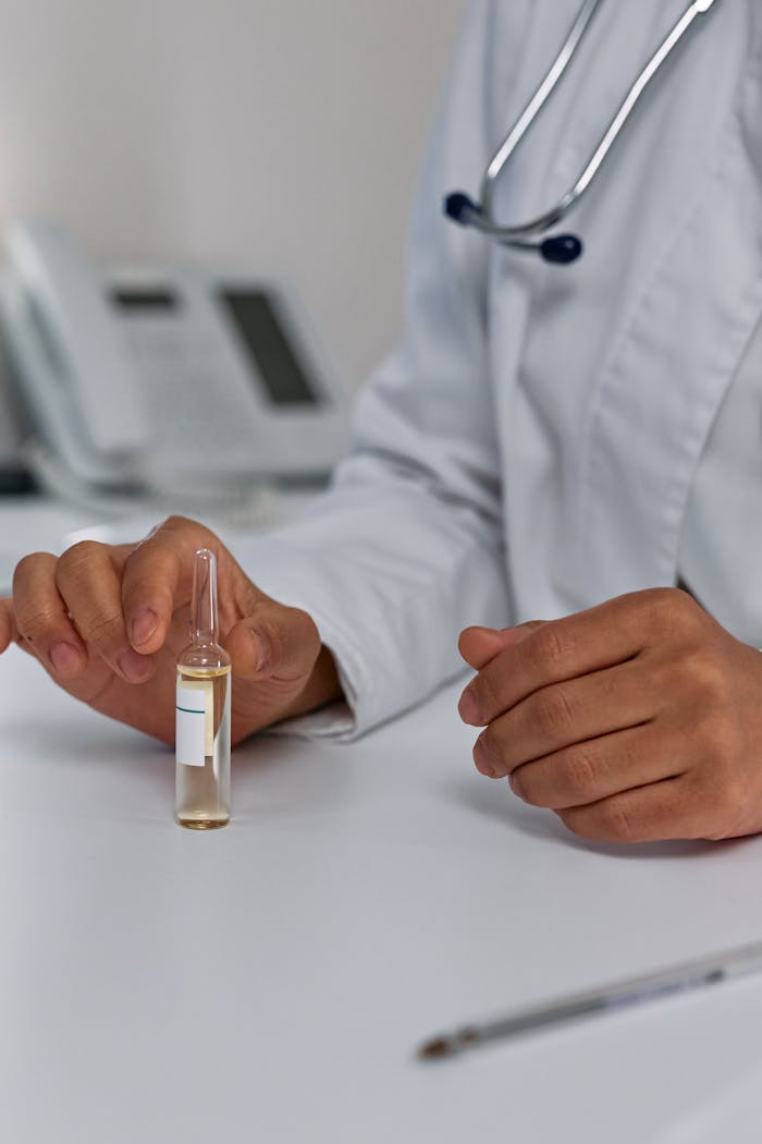 The Art of Drawing Readers In: Your attractive post title goes here Close-up of a doctors hands holding a medical ampoule on a desk in a clinical setting. Ideal for healthcare imagery.
