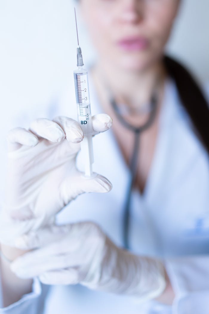 Close-up of a nurse holding a syringe, emphasizing healthcare and medical practice.